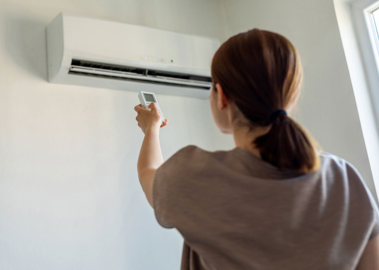 woman adjusting heat